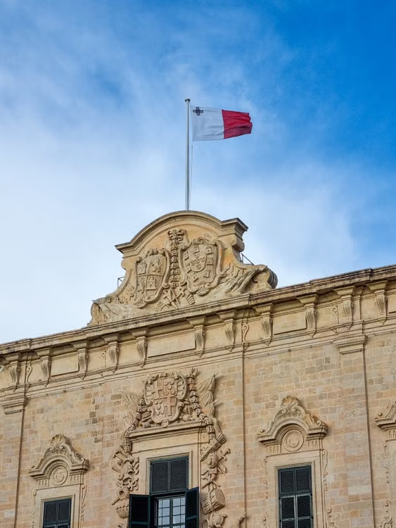 Maltese flag flying over the baroque Auberge de Castille in Valletta