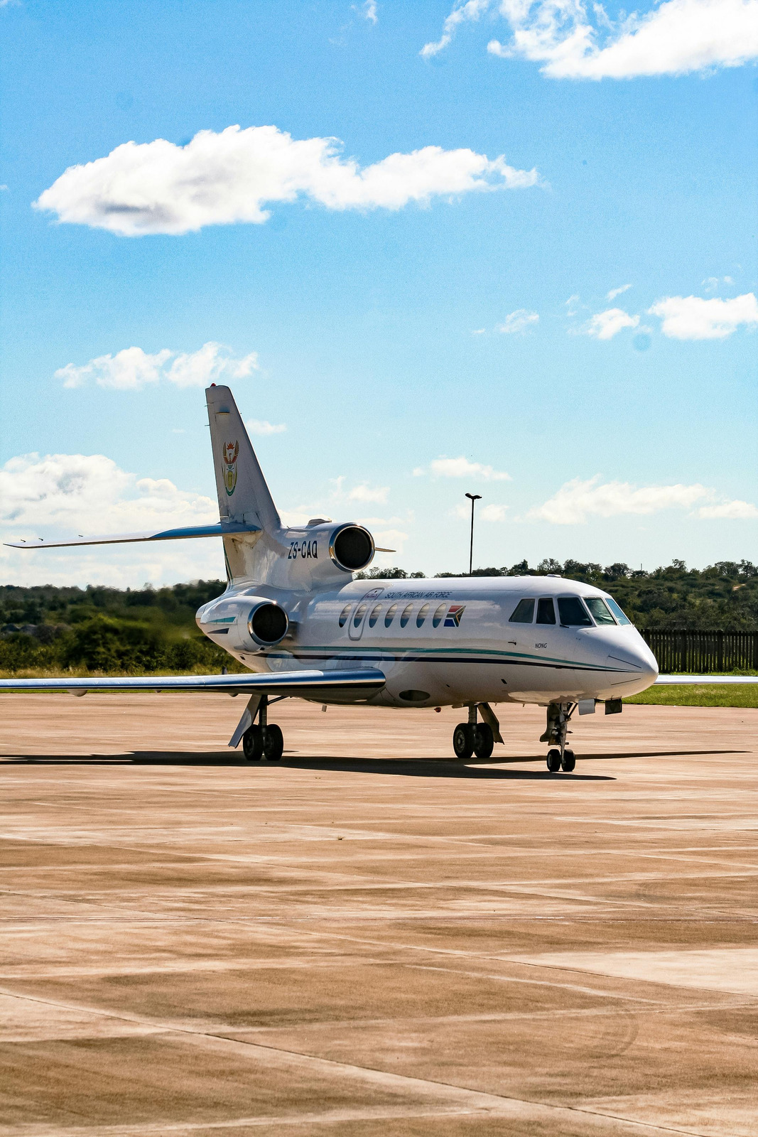 Private jet on the tarmac under a blue sky
